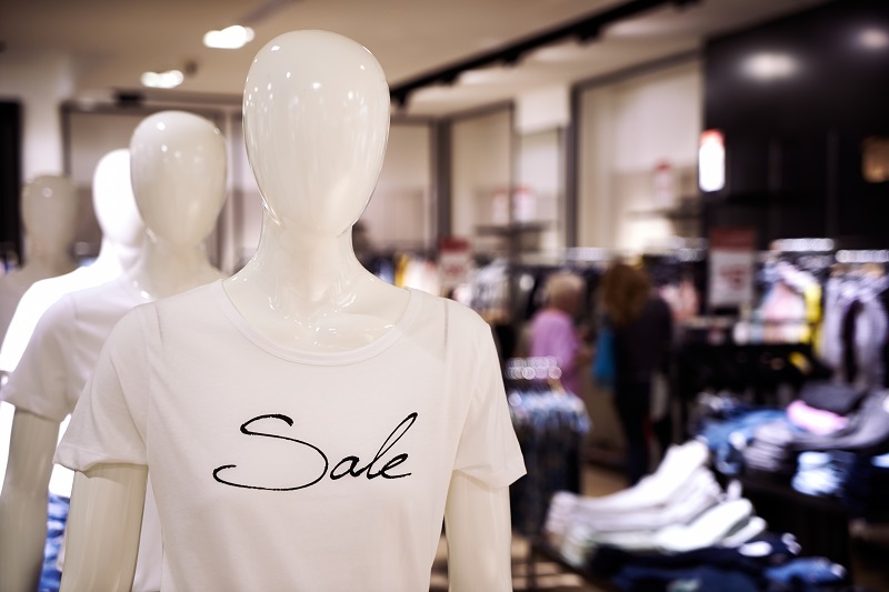 Clothing and retail store: view of clothes shop with t-shirt, jeans and shirts